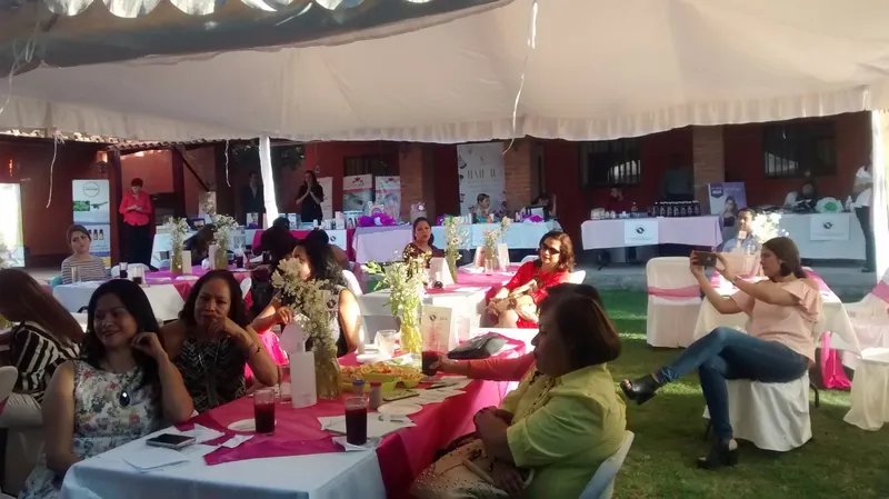 Encuentro con mujeres bajo una carpa, con mesas decoradas